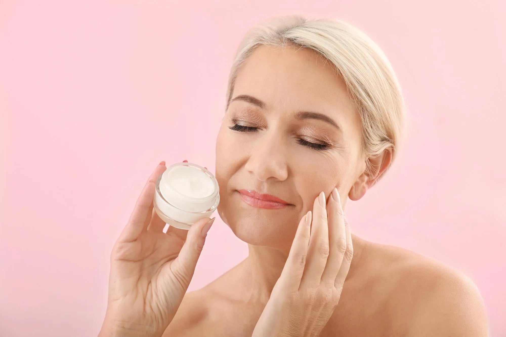 Woman applying face cream