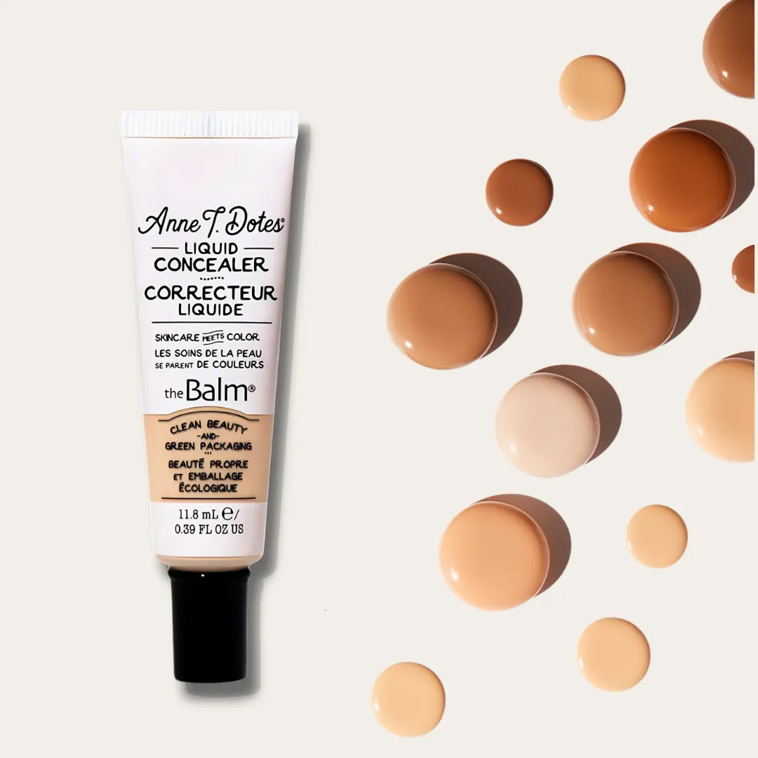 Cream tube next to droplets of concealer