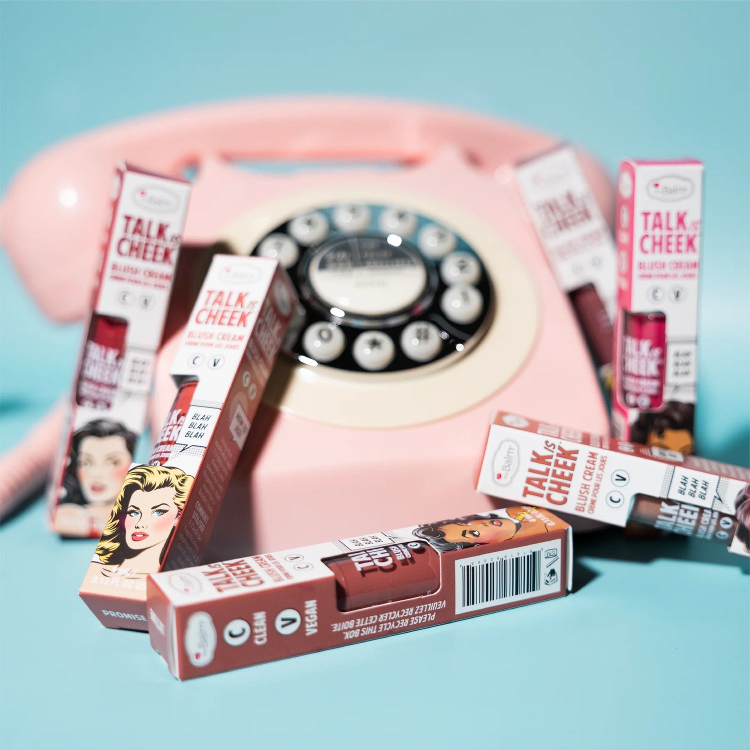 blush boxes surrounding rotary dial phone