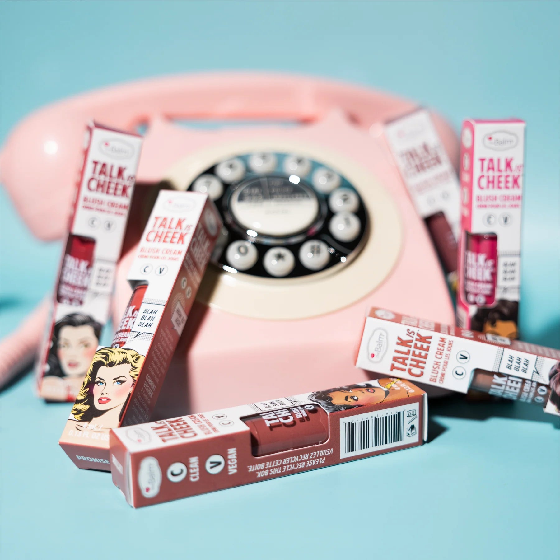 blush boxes surrounding rotary dial phone