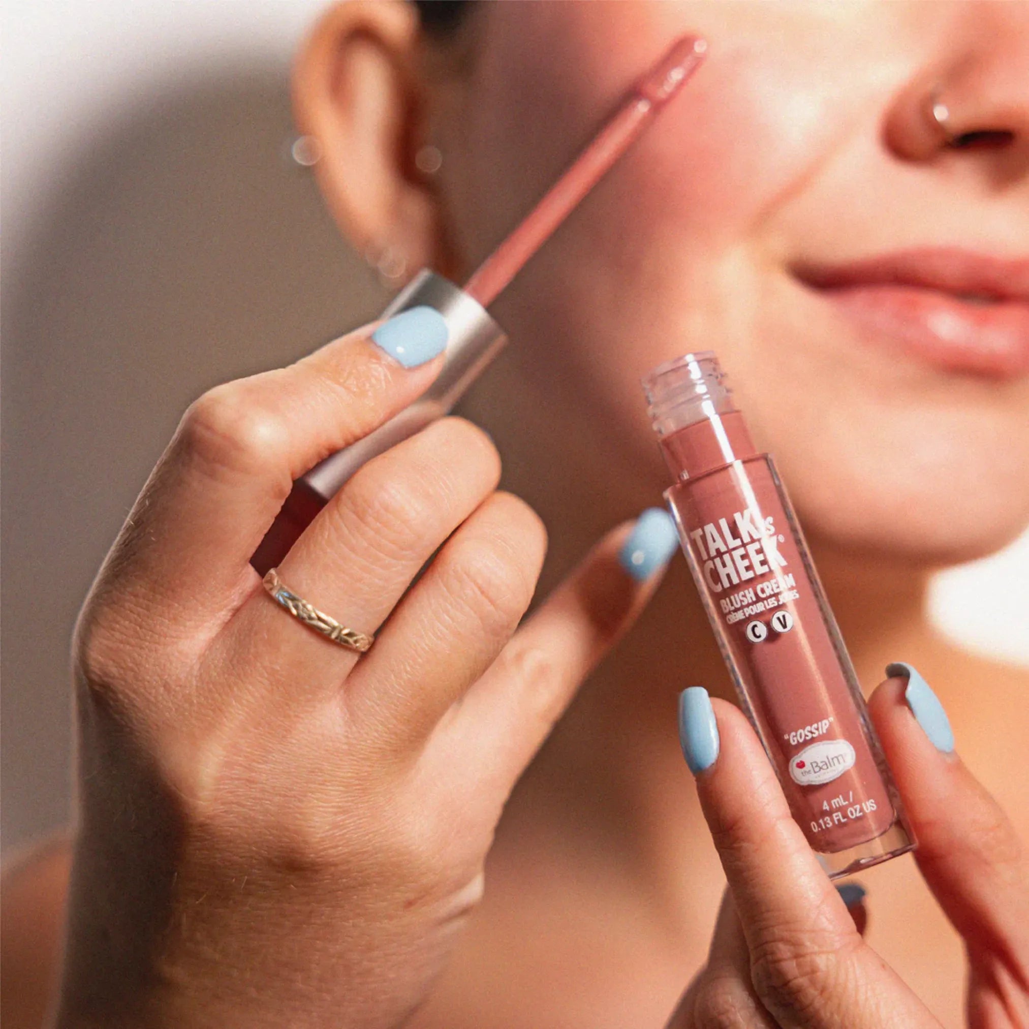 woman applying blush cream