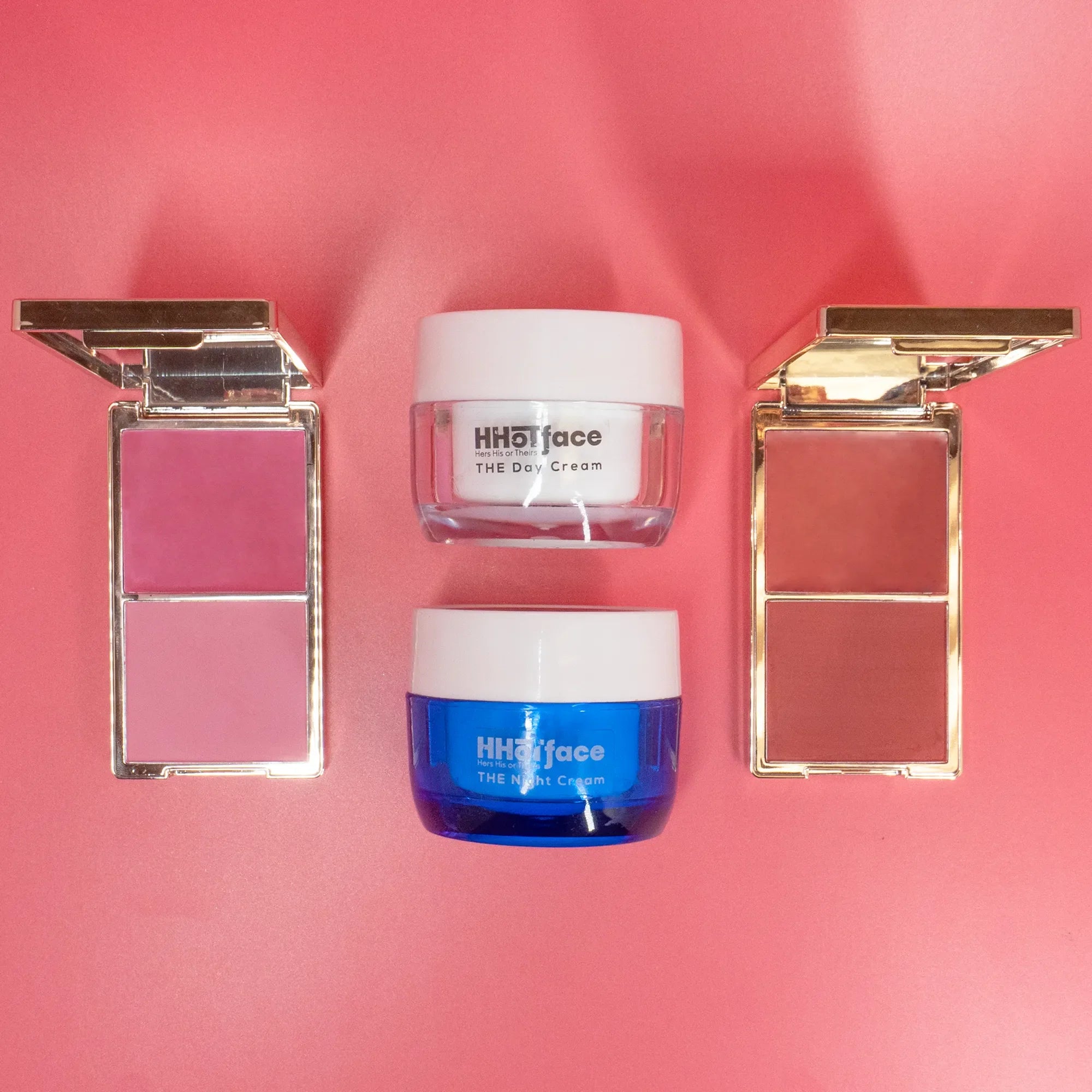 Two jars of face cream and two makeup compact cases on a pink background